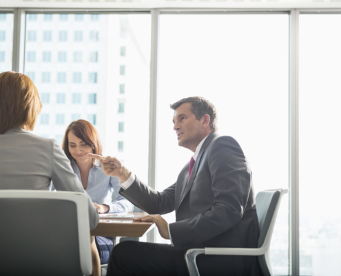 Businessman discussing with female team in conference room Business person at a conference table